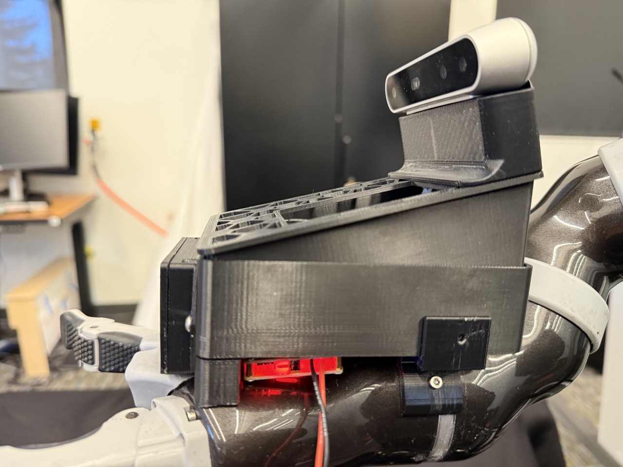 
                    This image shows the left-view of the robot arm's 6th joint, with
                    the arm mount screwed into it. A red circle highlights the screw on
                    this side of the arm mount.
                    