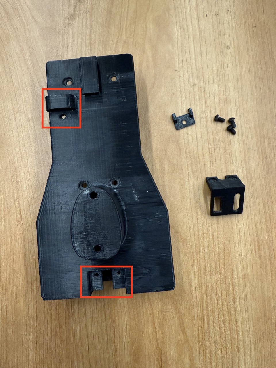 
                    This figure shows a photo of the wireless F/T mount, without the
                    mag cover and switch cover. The locations where the mag cover and
                    switch cover attach are shown in red.
                    